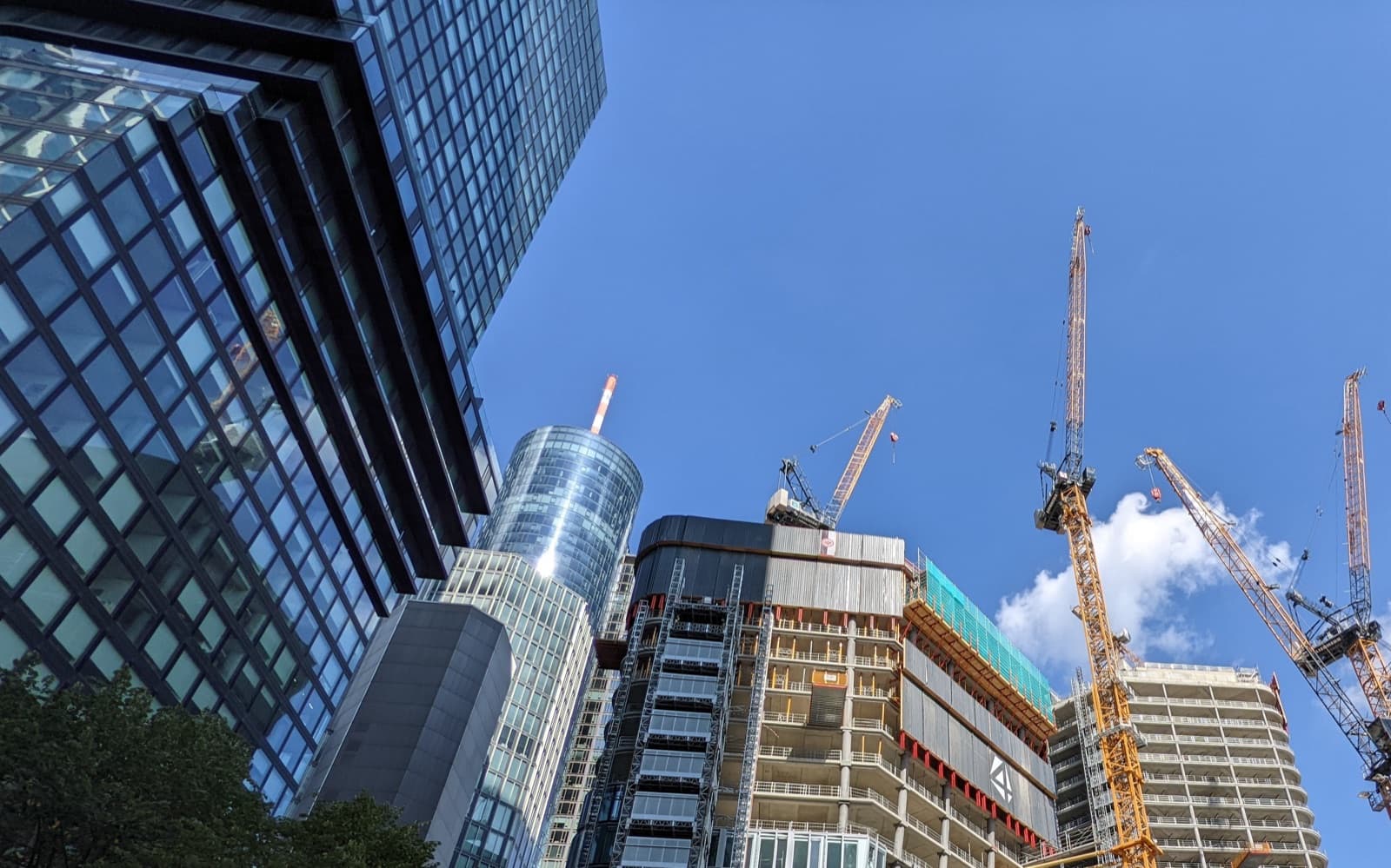 複数のタワークレーンが立ち並ぶ都市の建設現場